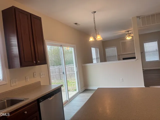 a view of a kitchen with a sink and dishwasher