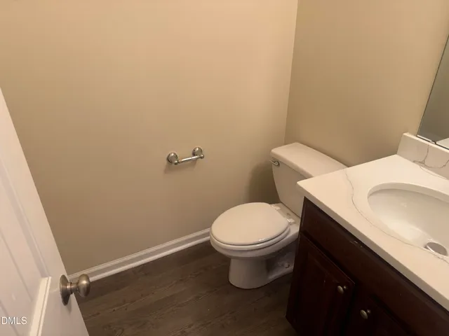 a white toilet sitting next to a bathroom sink