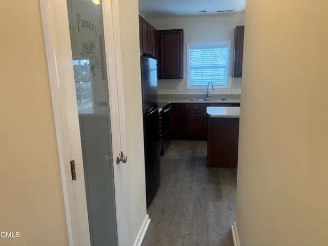 a kitchen with a sink and a refrigerator