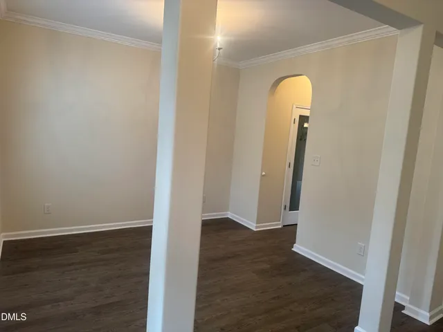 an empty room with wooden floor and closet