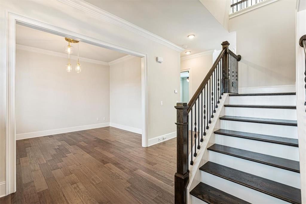 947 Hunter Way Milton, GA 30004 - Photo 43 of 78 a view of a hallway with wooden floor and stairs