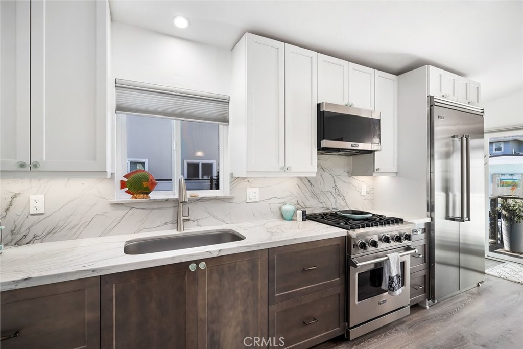 29 11th Street Cayucos, CA 93430 - Photo 12 of 55 a kitchen with stainless steel appliances a sink stove and microwave