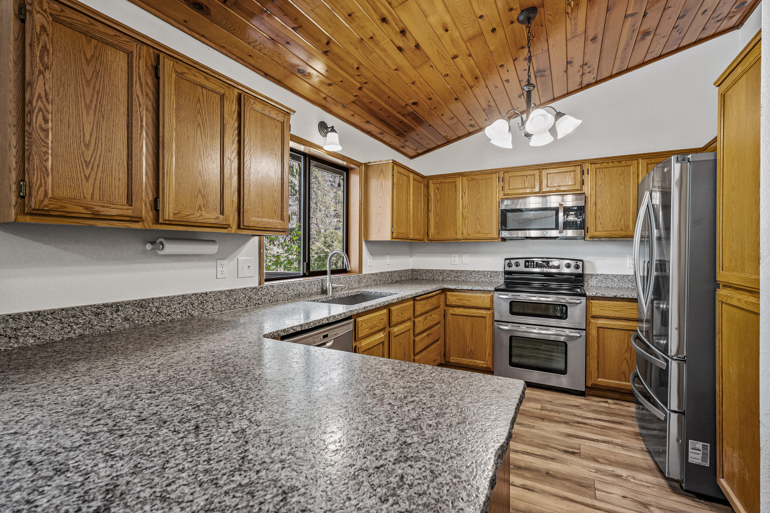 11744 Galice Road Merlin, OR 97532 - Photo 36 of 74 a kitchen with stainless steel appliances granite countertop a sink a stove and cabinets