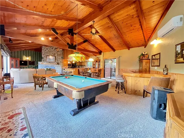a kitchen with stainless steel appliances granite countertop a table chairs and a refrigerator