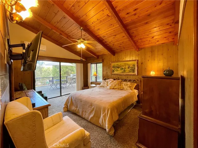 a view of a patio with dining table and chairs with wooden floor and fence