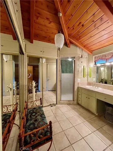 a bedroom with two beds and a ceiling fan