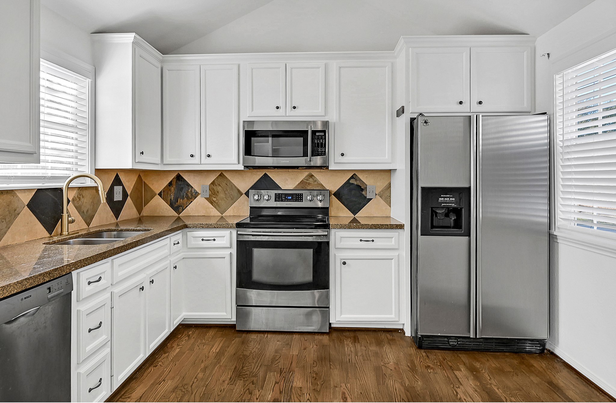 1959 Knoll Street Houston, TX 77080 - Photo 13 of 22 Kitchen with custom built cabinets, granite countertops, and stainless appliances.