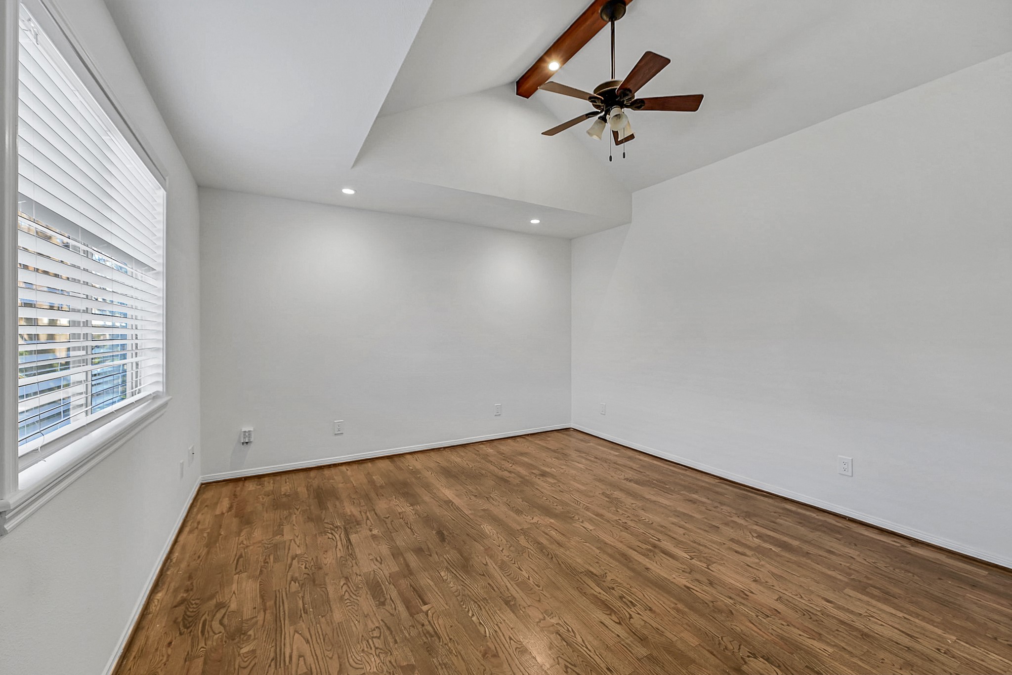 1959 Knoll Street Houston, TX 77080 - Photo 16 of 22 Spacious bedroom with vaulted ceiling, decorative beam, hardwoods and plenty of room for a king size bed and/or room for a desk if needed.