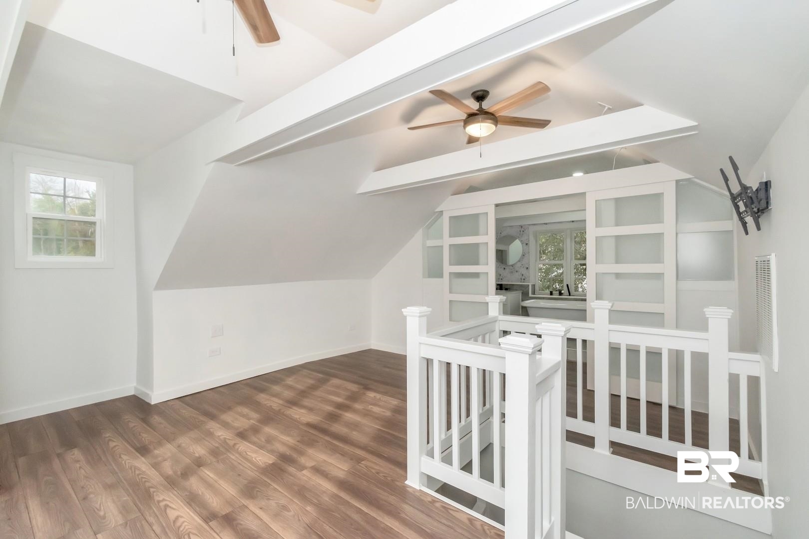 2157 Homewood Street Mobile, AL 36606 - Photo 12 of 36 Bonus room featuring a healthy amount of sunlight, baseboards, wood finished floors, and lofted ceiling