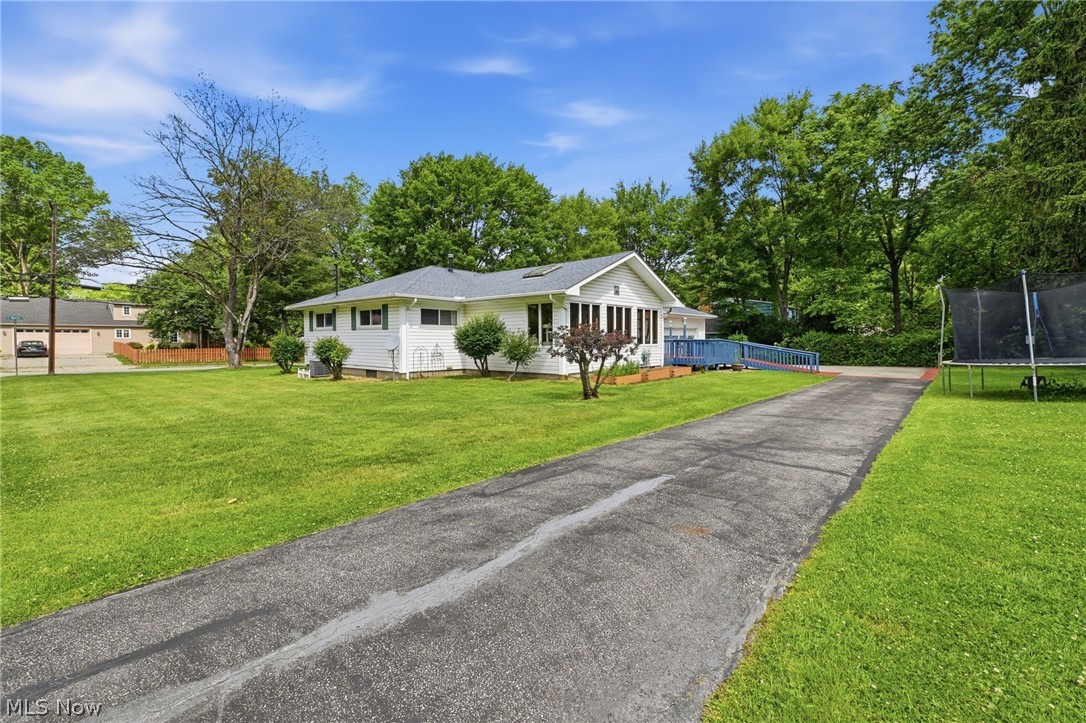 1499 Morris Road Kent, OH 44240 - Photo 36 of 41 Ranch-style residence featuring white siding and dark shutters, set on a spacious lawn with mature trees