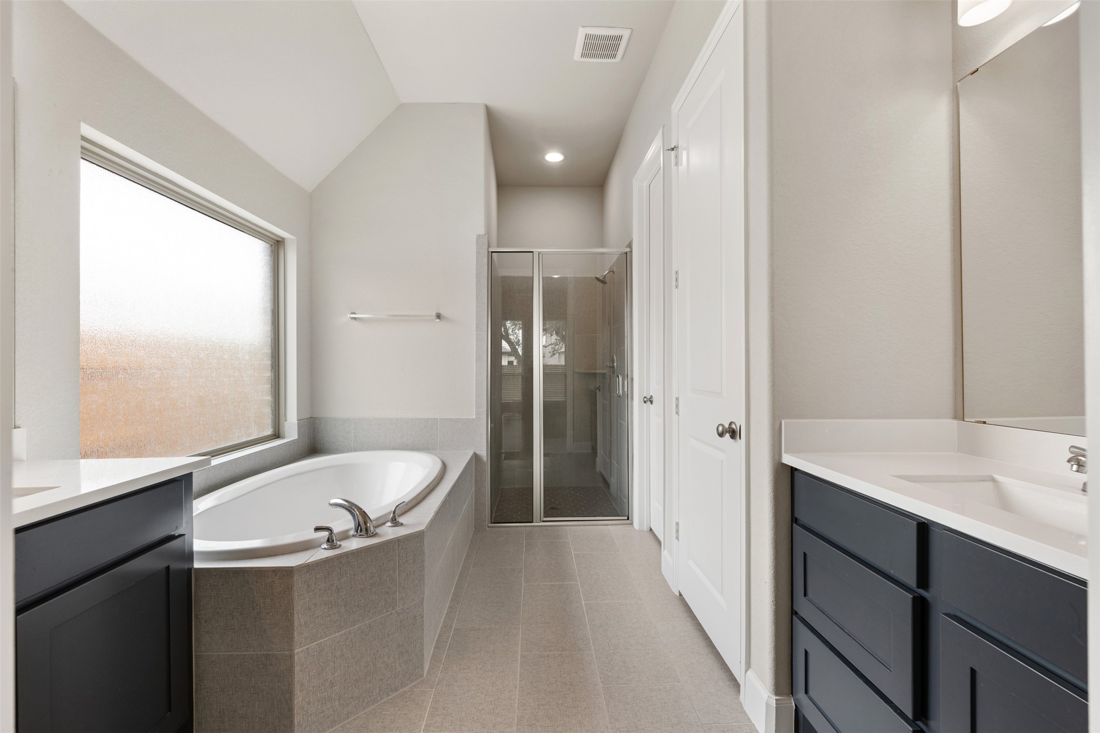 104 Anejo Bluff Georgetown, TX 78628 - Photo 28 of 40 a bathroom with a granite countertop sink mirror and a bathtub