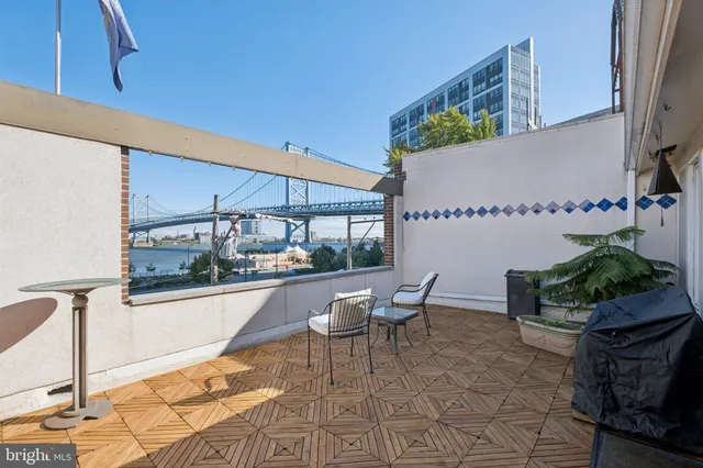 a terrace with outdoor seating and city view