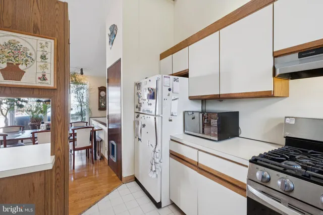 a kitchen with stainless steel appliances granite countertop a stove and a refrigerator