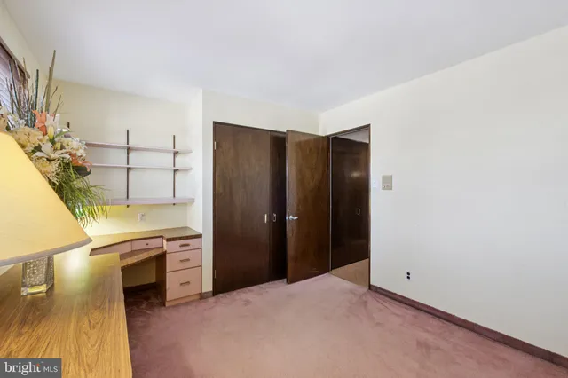 a view of a hallway with wooden floor and stairs