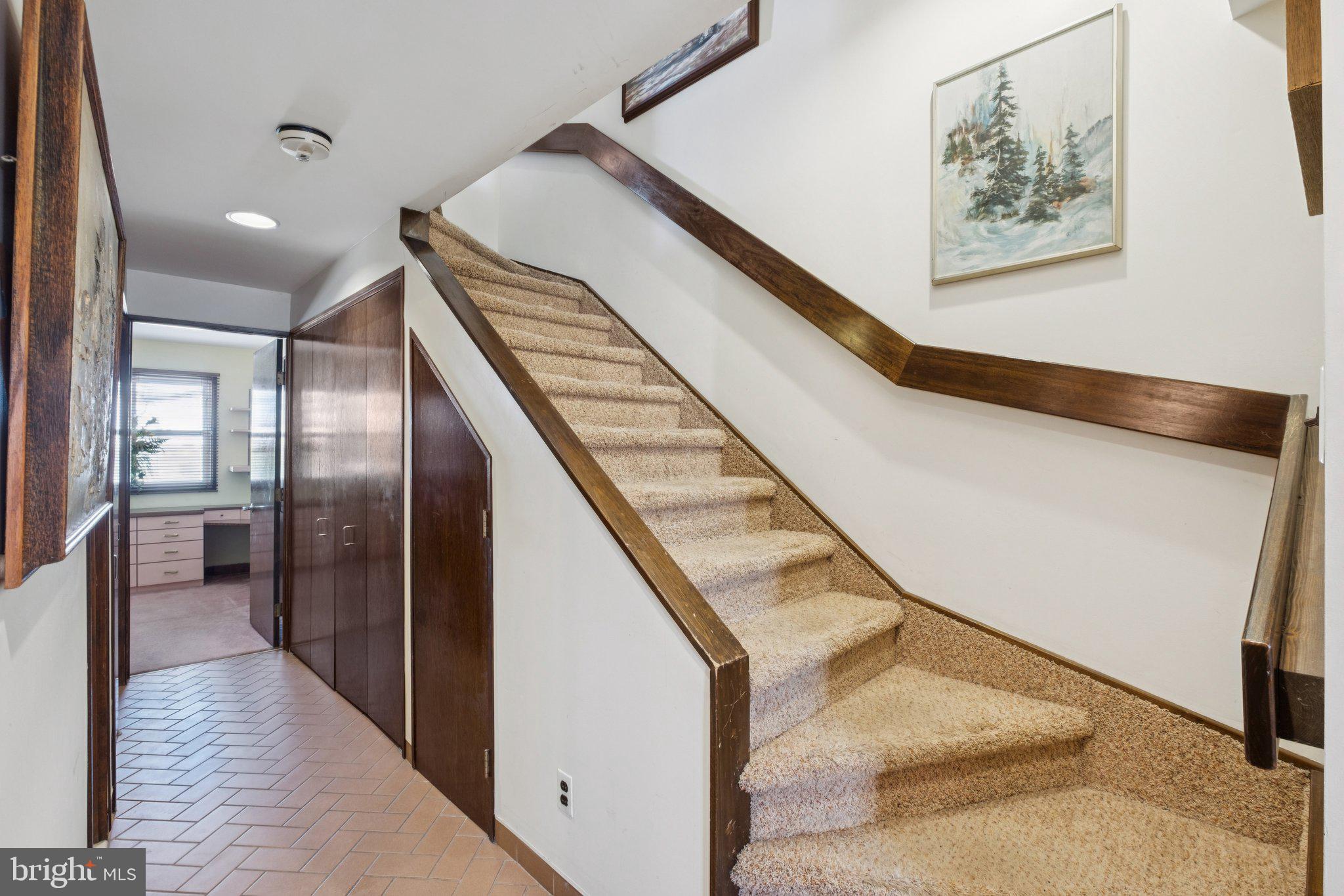 315 North Front Street, Unit 315 Philadelphia, PA 19106 - Photo 3 of 39 a view of staircase with lots of frames on wall and stainless steel appliances