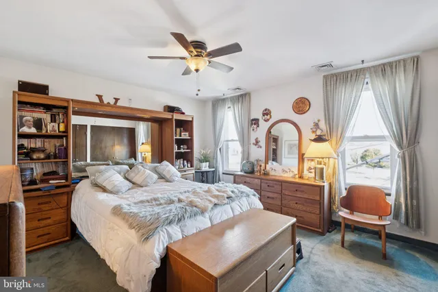 a bedroom with a bed and dresser