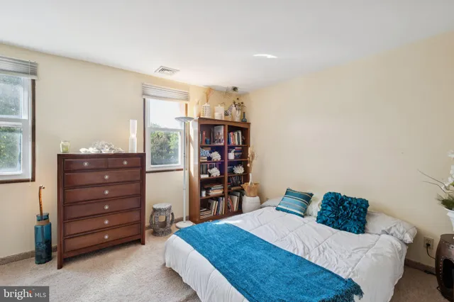 a bedroom with a bed and a bookshelf