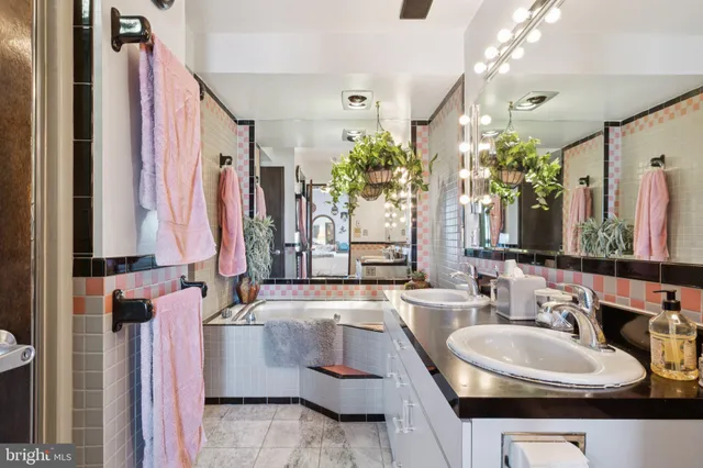 a bathroom with a double vanity sink and a mirror