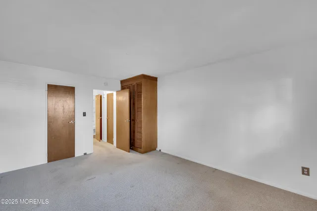 a view of an empty room and closet area