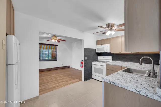 a kitchen with a sink a stove and cabinets