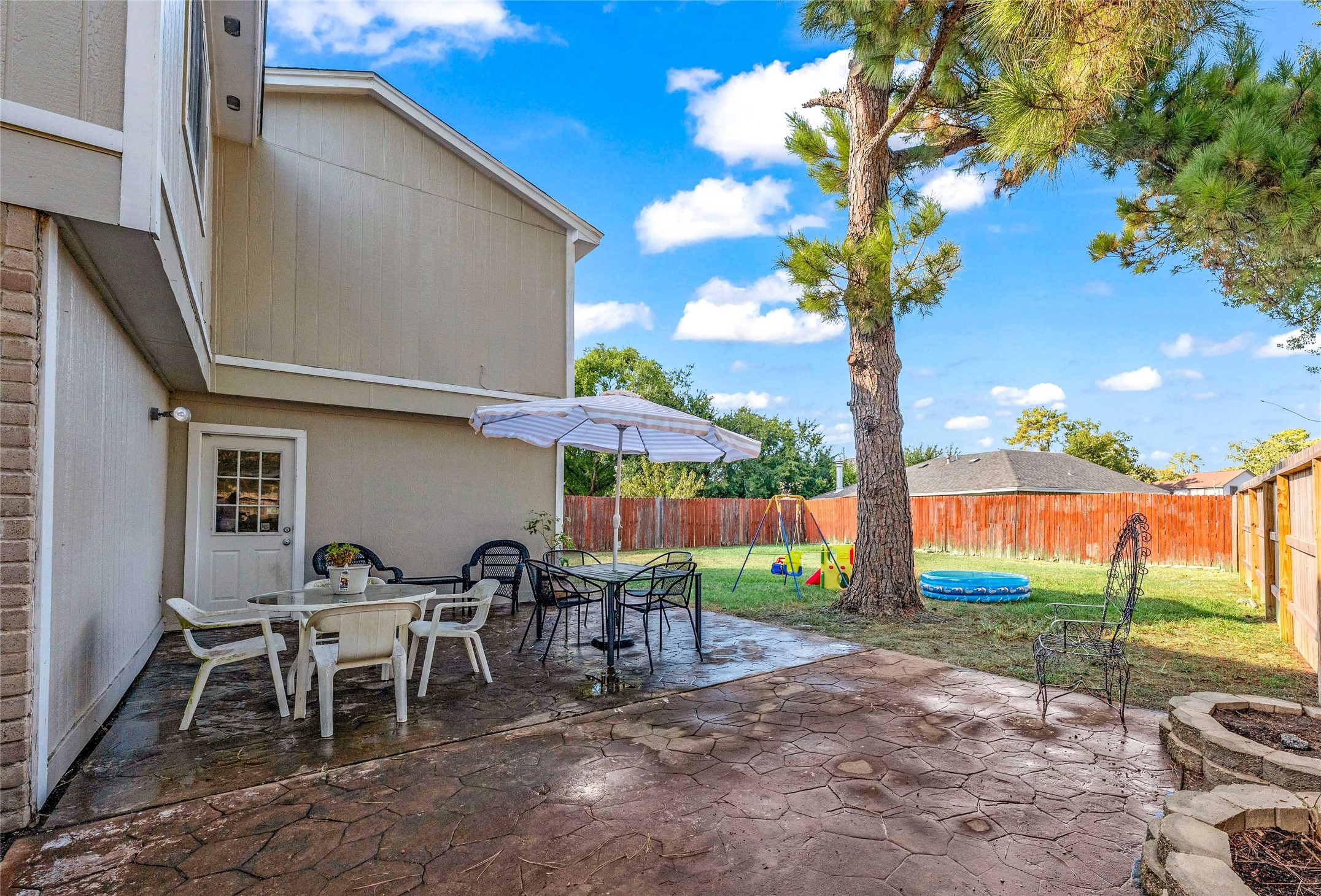 24014 Red Sky Drive Spring, TX 77373 - Photo 2 of 23 a backyard of a house with table and chairs
