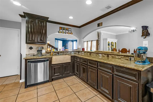 a kitchen with stainless steel appliances granite countertop a sink and cabinets