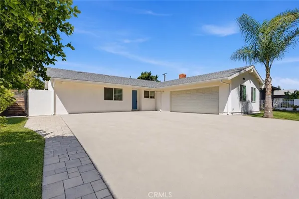 a front view of a house with a yard and a garage
