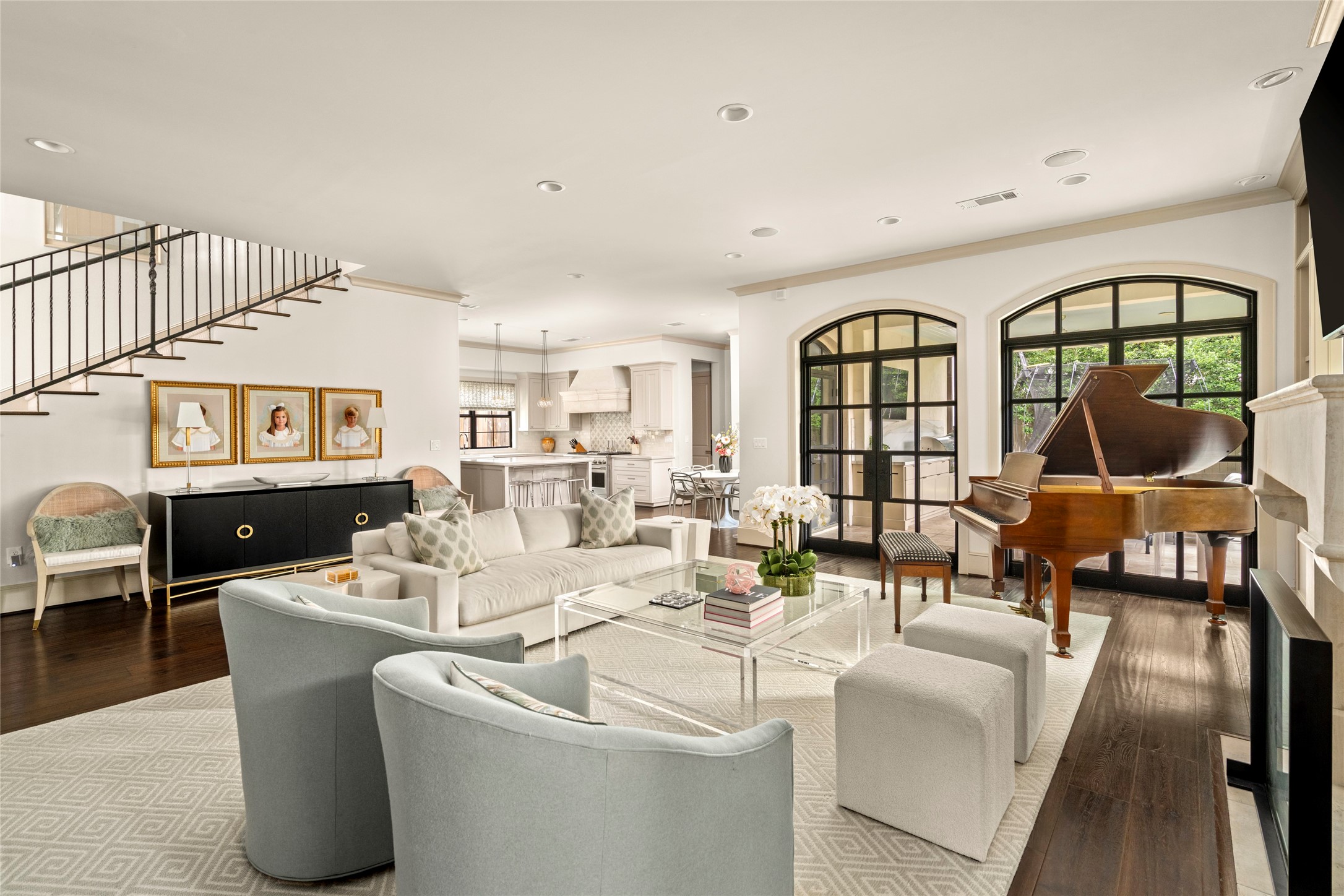2216 Stanmore Drive Houston, TX 77019 - Photo 14 of 46 A spacious, open-concept layout connects the family room, stair hall, kitchen, and outdoor living area, offering an easy flow for both daily living and entertaining.