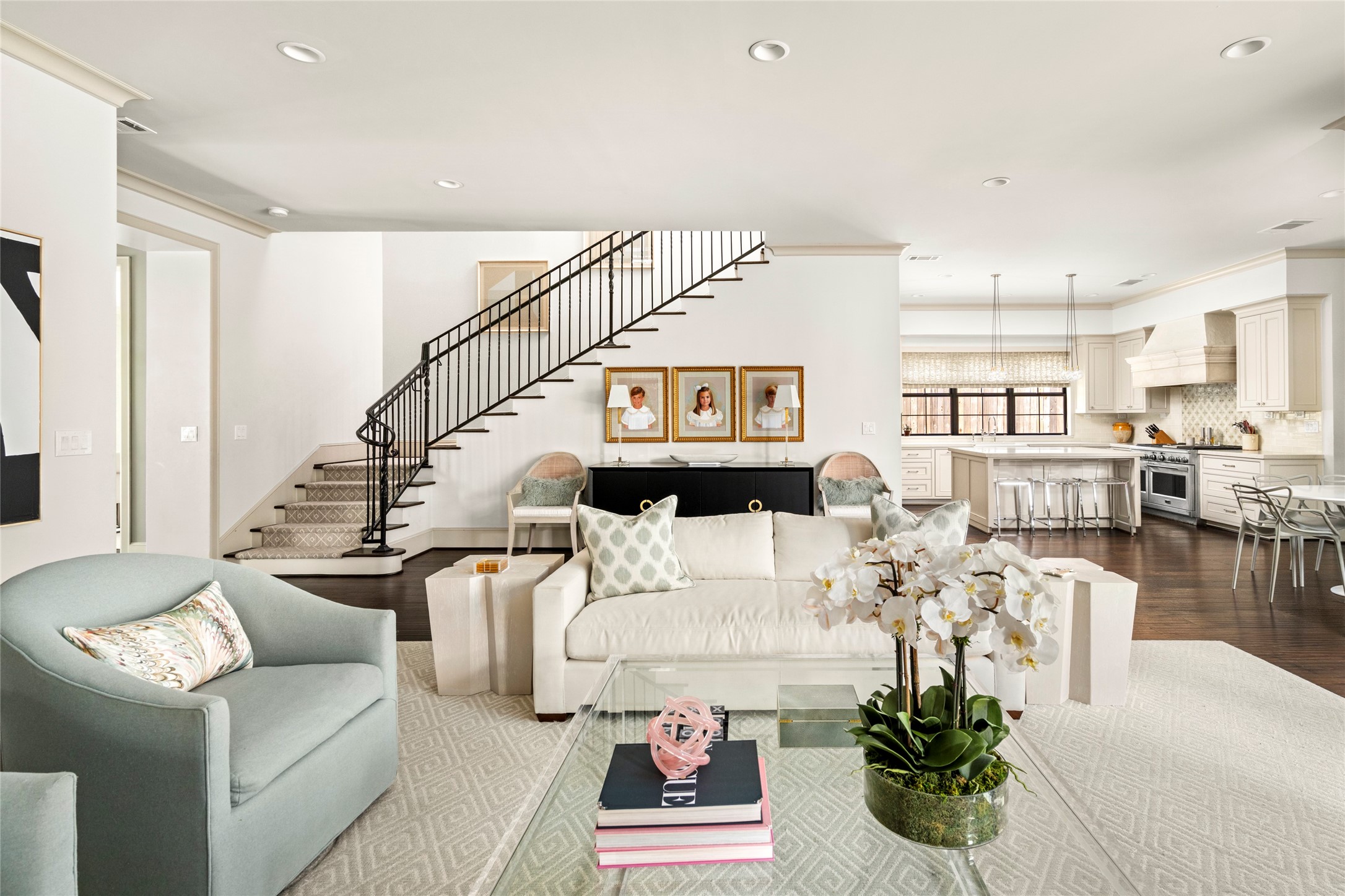 2216 Stanmore Drive Houston, TX 77019 - Photo 15 of 46 Clean sightlines from the living area to the kitchen highlight the home’s open layout, with dark hardwood floors, a graceful stairway, and bright everyday living spaces.