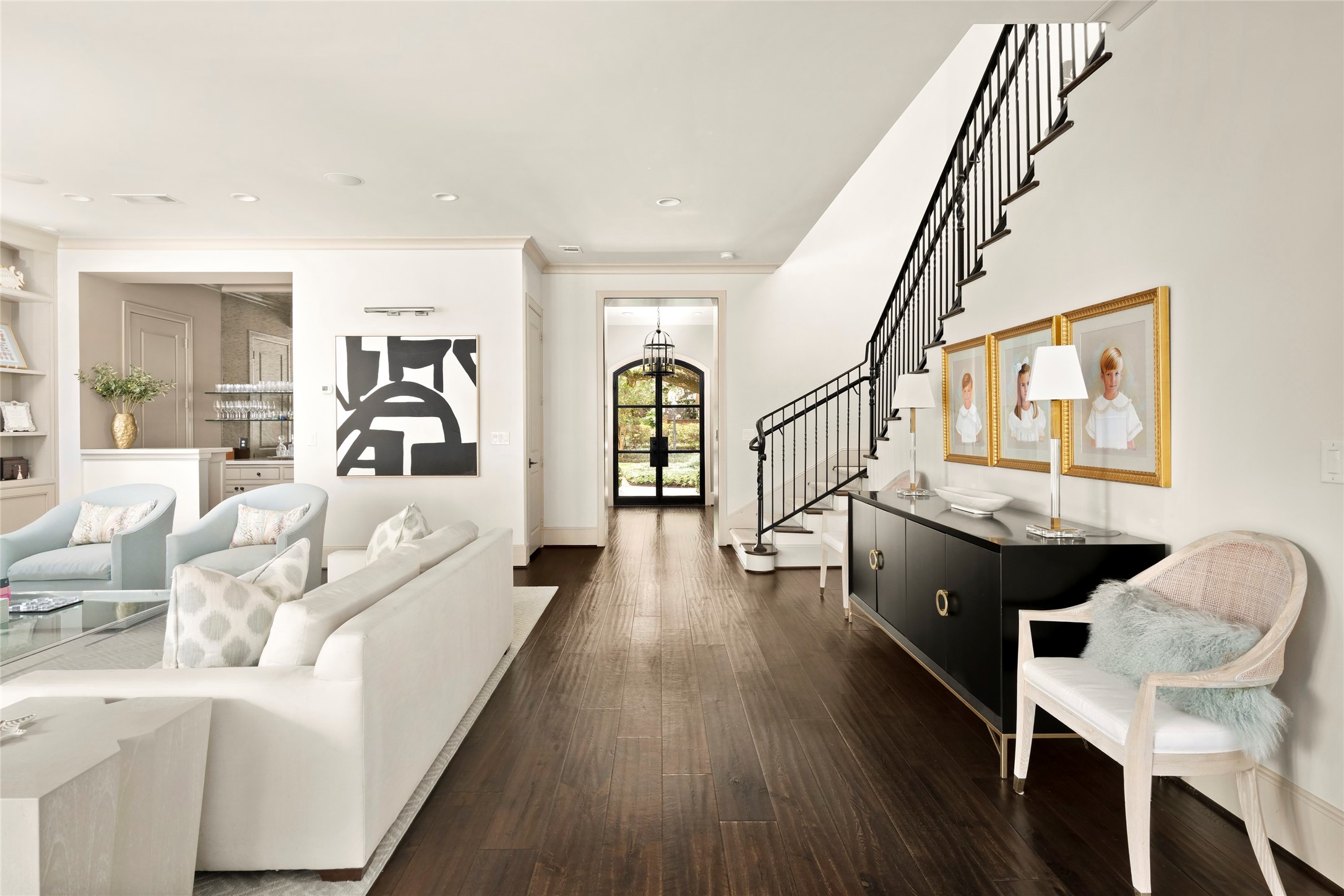 2216 Stanmore Drive Houston, TX 77019 - Photo 17 of 46 Light-filled living spaces flow seamlessly from the entry hall, with hardwood floors, custom iron stair railing, built-ins, and open sightlines that create an elegant, connected main level.
