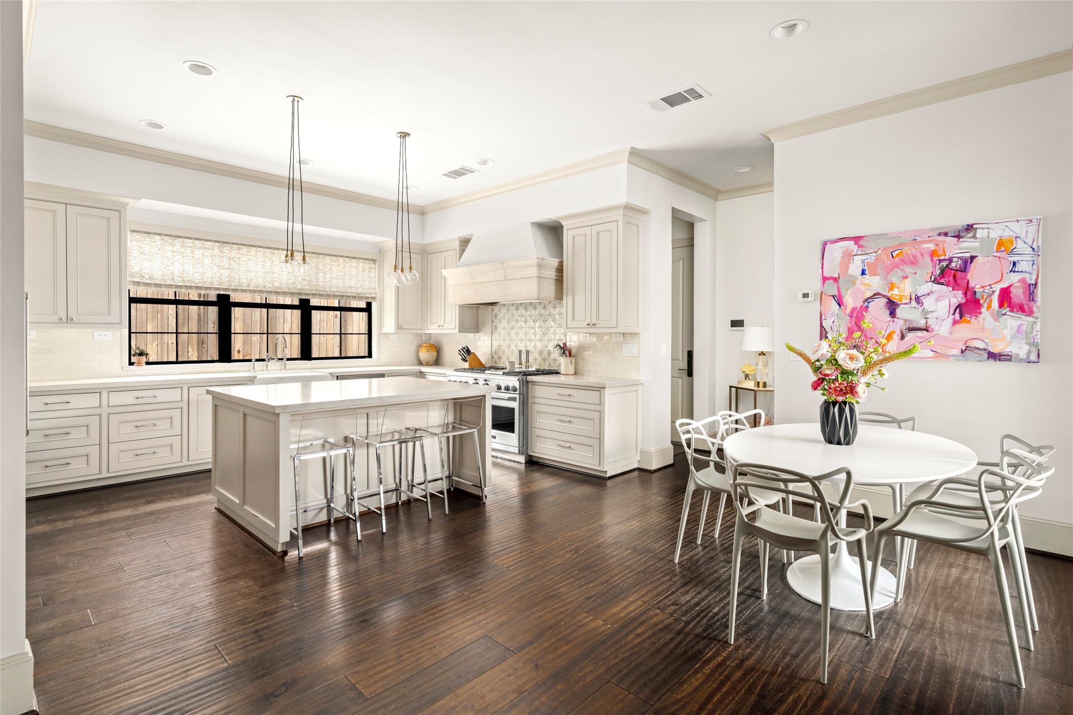 2216 Stanmore Drive Houston, TX 77019 - Photo 20 of 46 The kitchen features a generous center island, custom cabinetry, GE Monogram appliances, and Circa pendant lighting that adds a refined designer detail above the island.