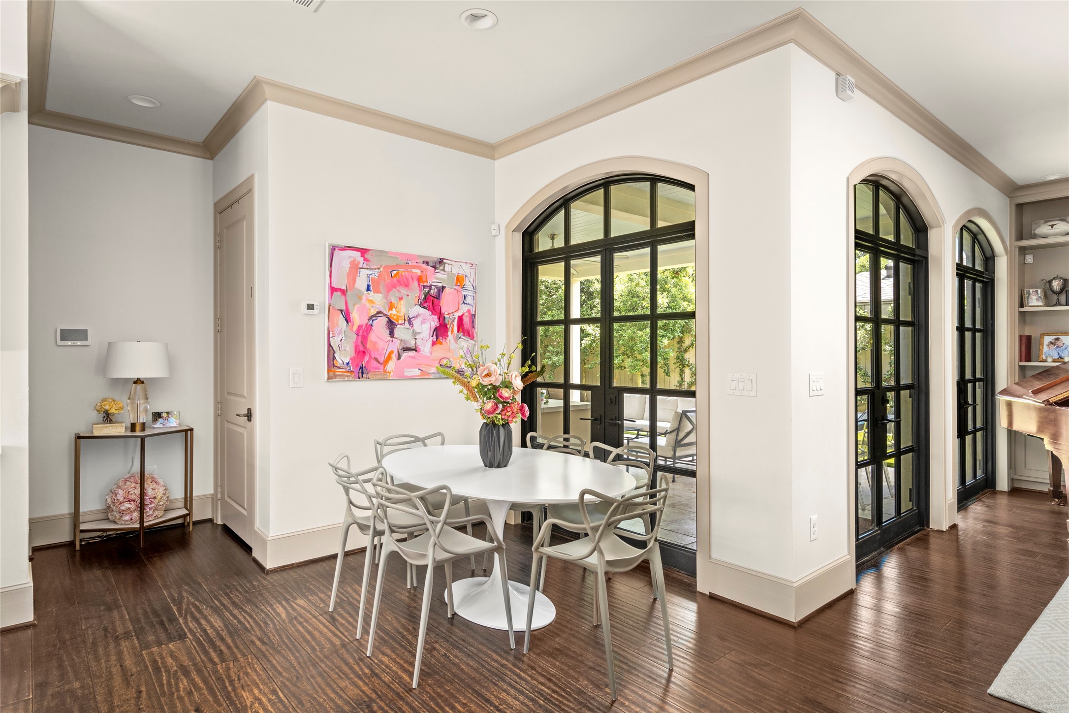 2216 Stanmore Drive Houston, TX 77019 - Photo 21 of 46 The breakfast area sits just off the kitchen, framed by arched steel doors that open to the covered outdoor living area for effortless indoor-outdoor connection.