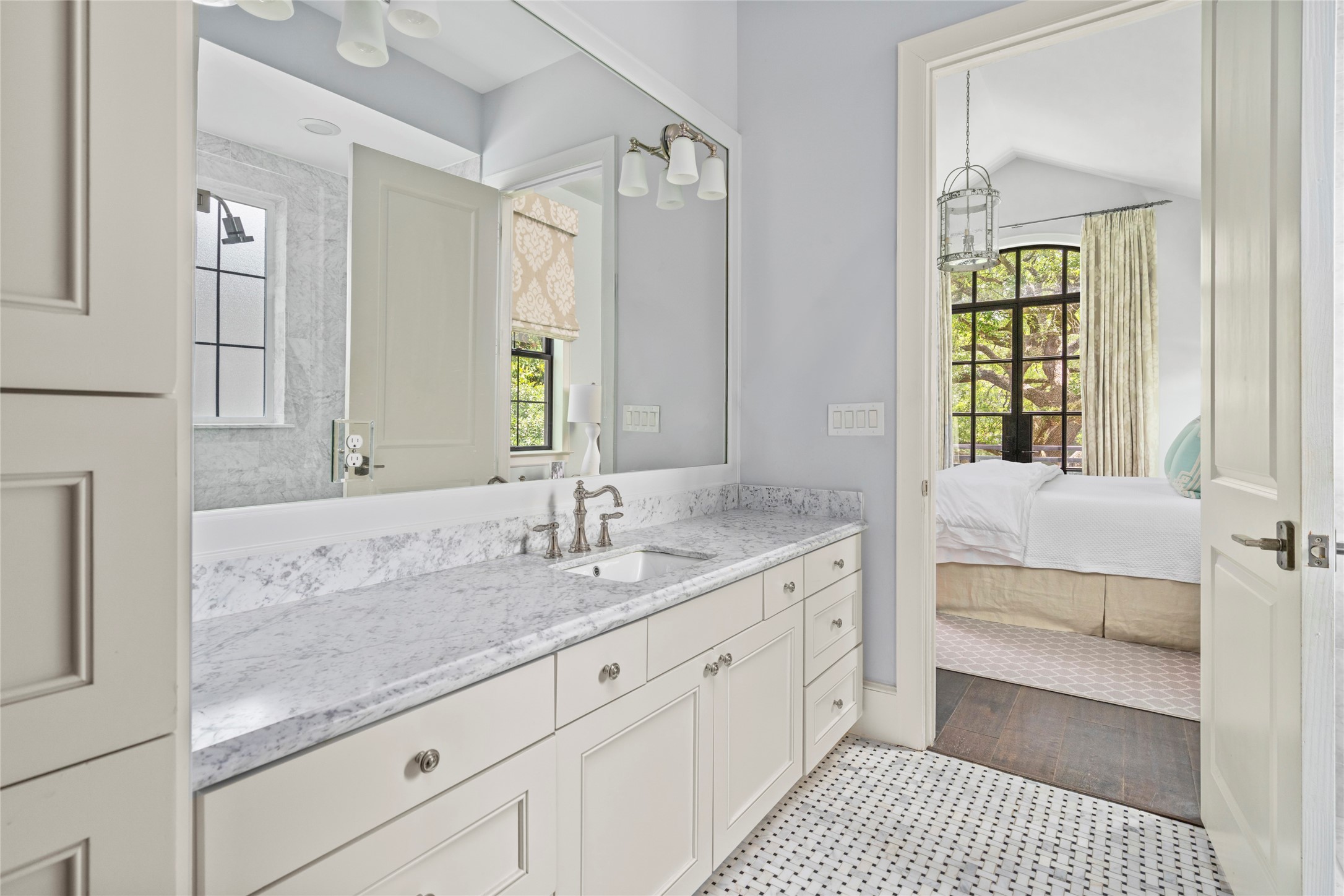 2216 Stanmore Drive Houston, TX 77019 - Photo 27 of 46 Light-filled primary bath 1 with marble counters, custom cabinetry, mosaic marble flooring, and direct connection to the primary bedroom.