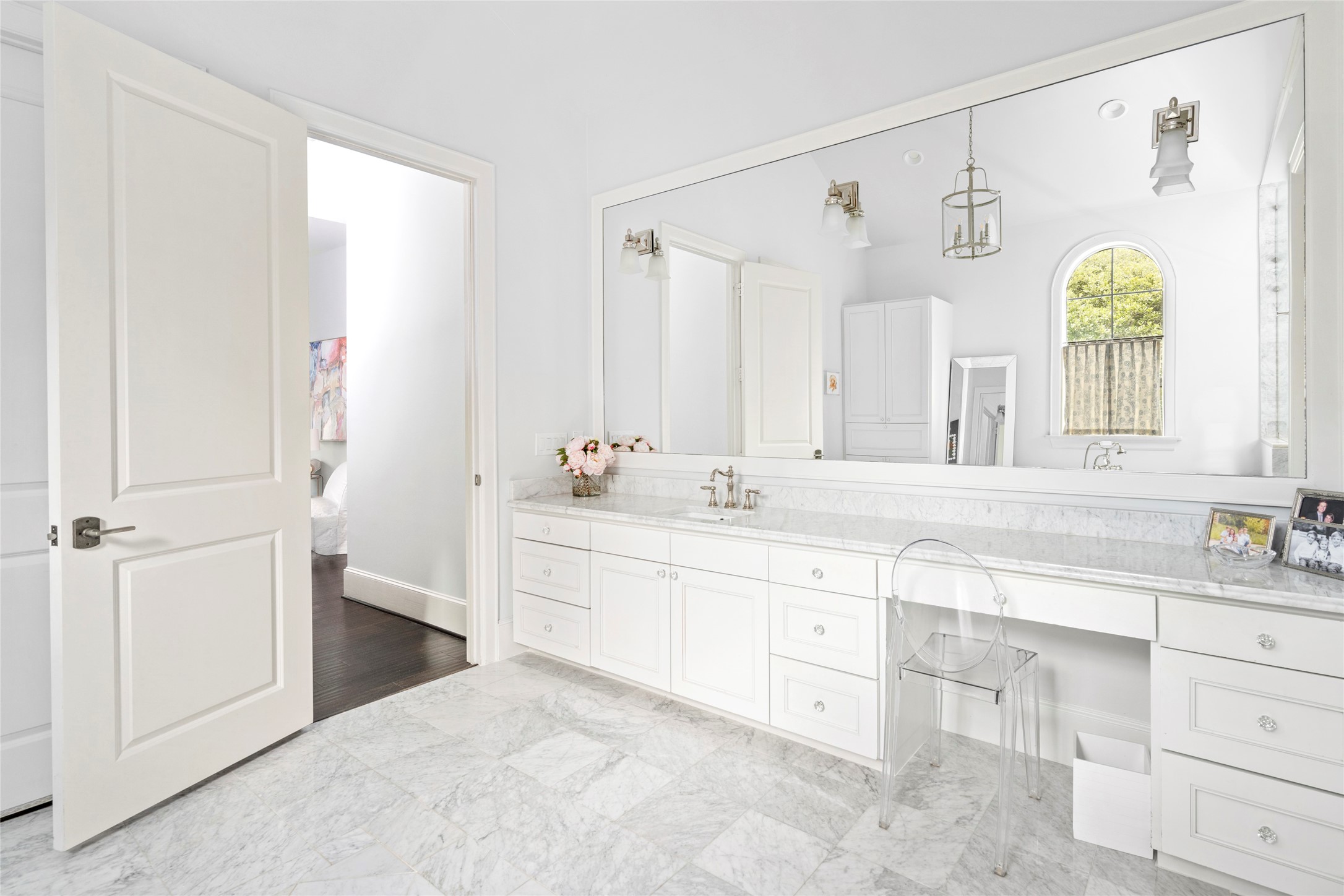 2216 Stanmore Drive Houston, TX 77019 - Photo 29 of 46 Expansive vanity with marble surfaces, abundant cabinetry, and a dedicated seated makeup area within the private primary bath 2.