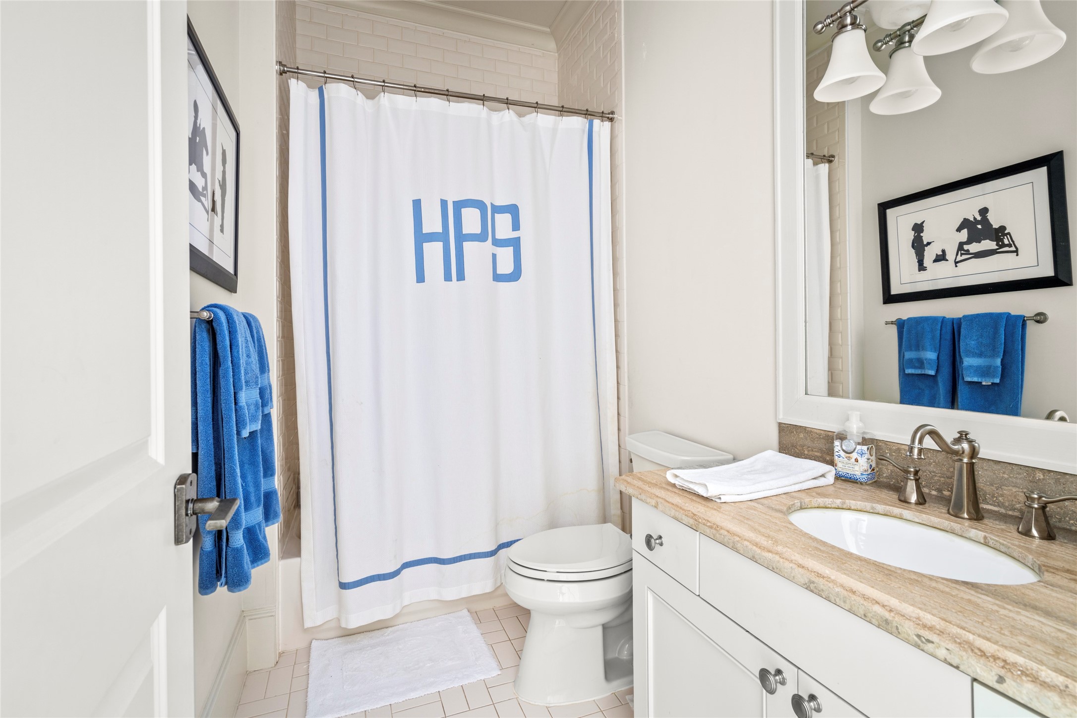2216 Stanmore Drive Houston, TX 77019 - Photo 34 of 46 Private en-suite bath with a tub/shower combination, classic tile surround, stone vanity counter, and polished fixtures.