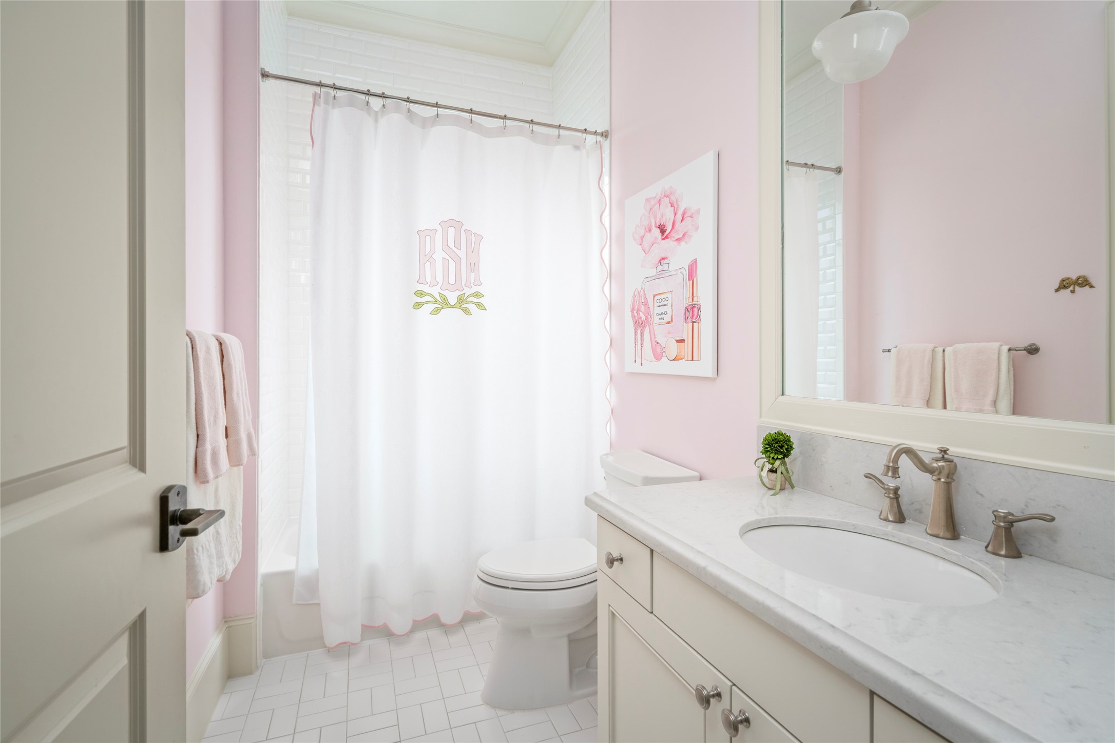 2216 Stanmore Drive Houston, TX 77019 - Photo 38 of 46 Charming en-suite bath with soft pink walls, marble vanity, and a tub/shower combination, also accessible from the hallway for convenient use from the upstairs game room.