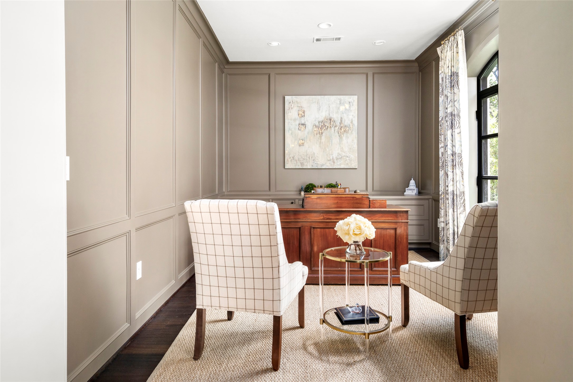 2216 Stanmore Drive Houston, TX 77019 - Photo 7 of 46 First-floor study with tailored wall paneling, hardwood floors, and a quiet, polished setting ideal for a private office or sitting room.