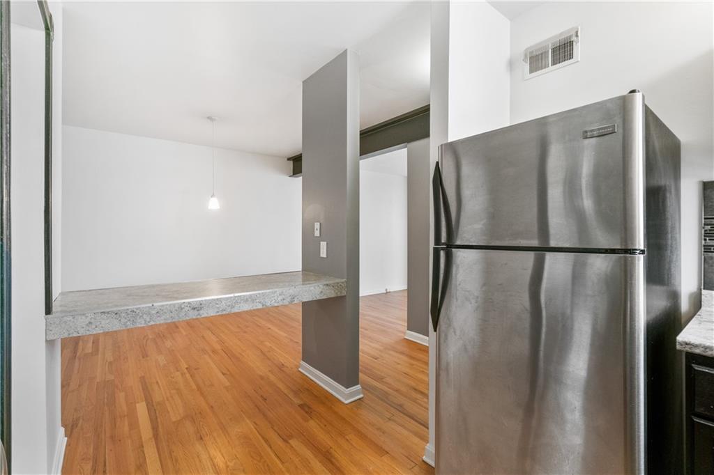 675 College Street, Unit A Pittsburgh, PA 15232 - Photo 11 of 28 a view of a refrigerator in kitchen and wooden floor