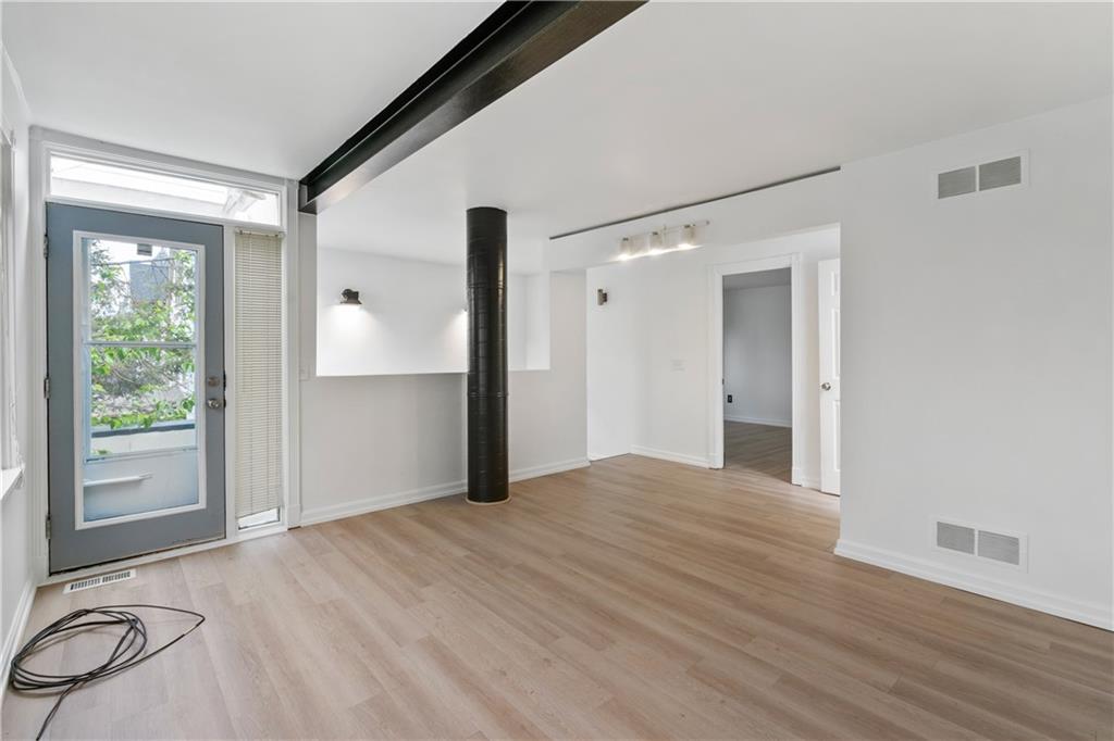 675 College Street, Unit A Pittsburgh, PA 15232 - Photo 15 of 28 a view of an empty room with wooden floor and a window