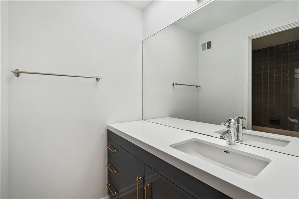 675 College Street, Unit A Pittsburgh, PA 15232 - Photo 22 of 28 a bathroom with a sink and a mirror