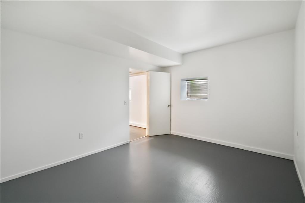 675 College Street, Unit A Pittsburgh, PA 15232 - Photo 24 of 28 an empty room with wooden floor and white walls