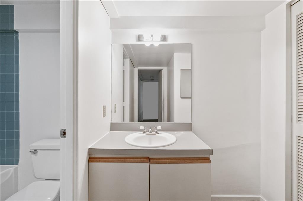 675 College Street, Unit A Pittsburgh, PA 15232 - Photo 27 of 28 a bathroom with a sink and a mirror