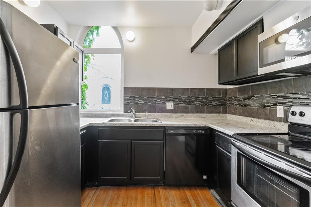 675 College Street, Unit A Pittsburgh, PA 15232 - Photo 8 of 28 a kitchen with stainless steel appliances granite countertop a sink stove and refrigerator