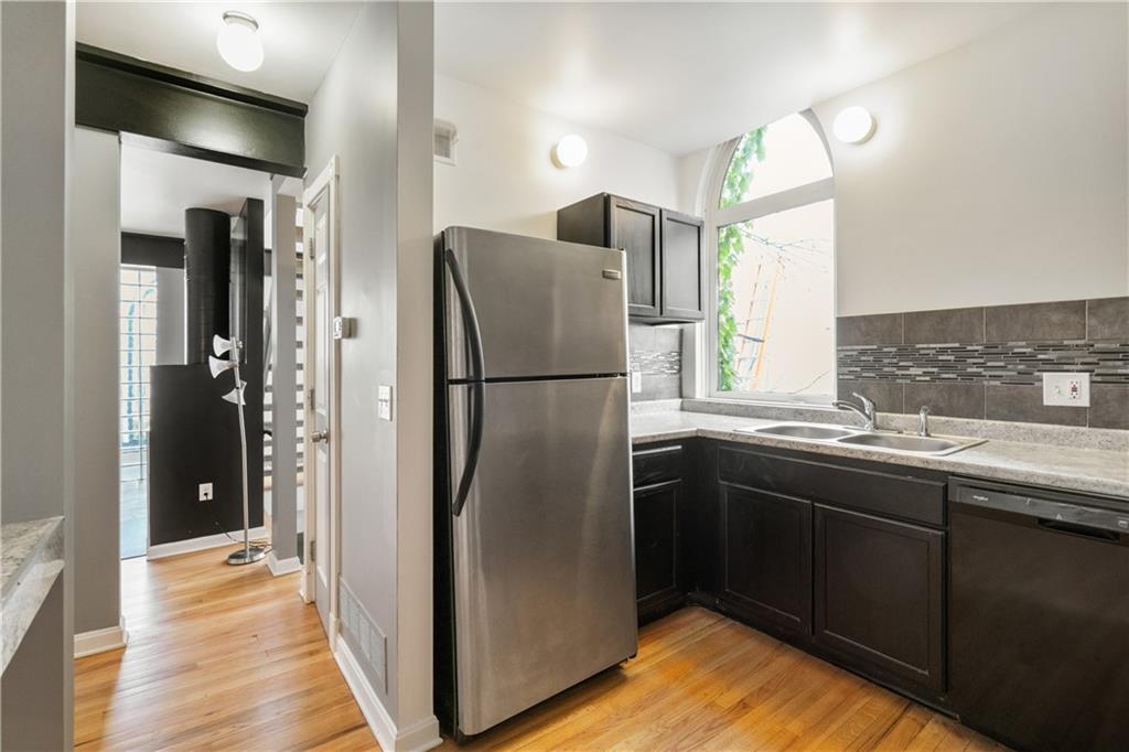 675 College Street, Unit A Pittsburgh, PA 15232 - Photo 10 of 28 a kitchen with stainless steel appliances granite countertop a refrigerator and a sink