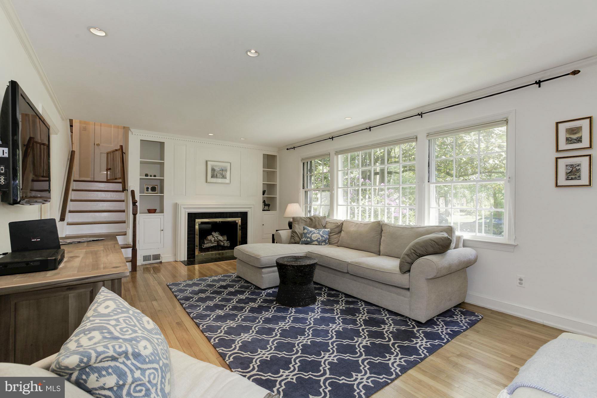 5608 Pollard Road Bethesda, MD 20816 - Photo 2 of 18 a living room with furniture large window and a fireplace