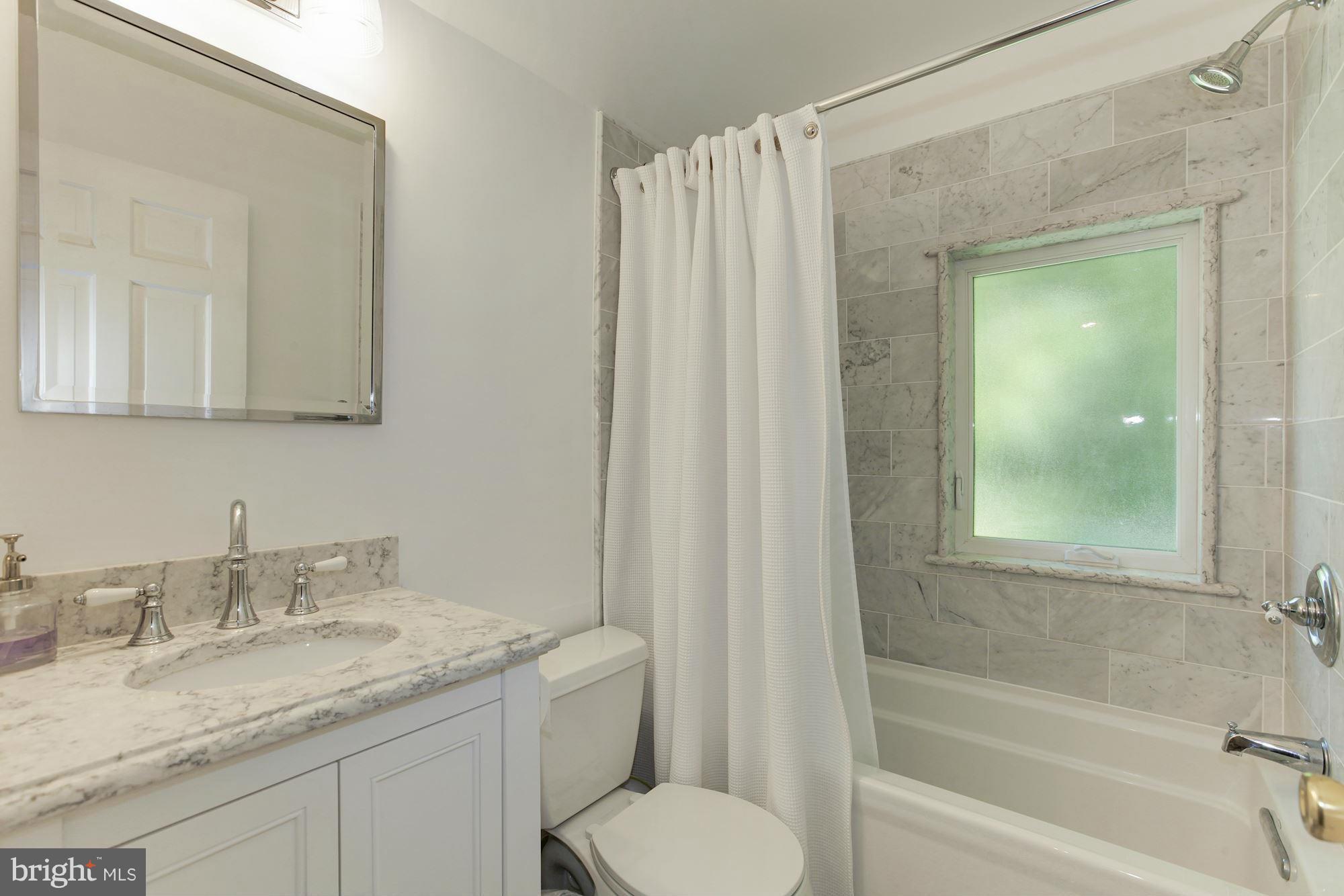 5608 Pollard Road Bethesda, MD 20816 - Photo 12 of 18 a bathroom with a granite countertop sink toilet and shower