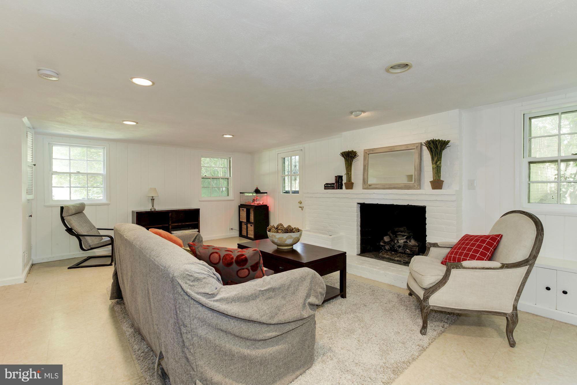 5608 Pollard Road Bethesda, MD 20816 - Photo 14 of 18 a living room with furniture and a fireplace