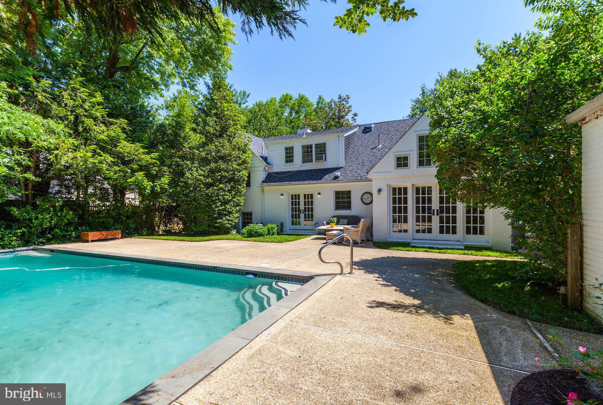 5608 Pollard Road Bethesda, MD 20816 - Photo 15 of 18 a front view of a house with swimming pool having outdoor seating