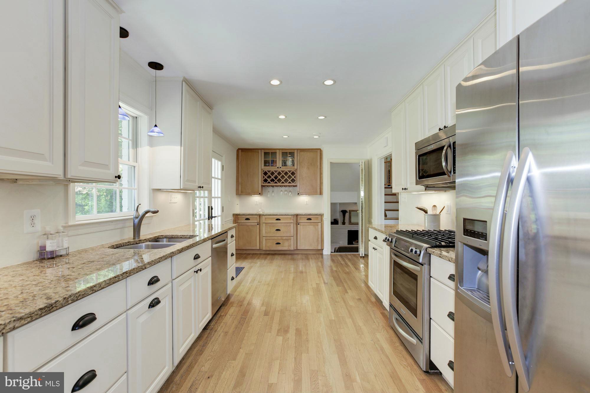 5608 Pollard Road Bethesda, MD 20816 - Photo 6 of 18 a large kitchen with stainless steel appliances granite countertop a lot of counter space and wooden floor