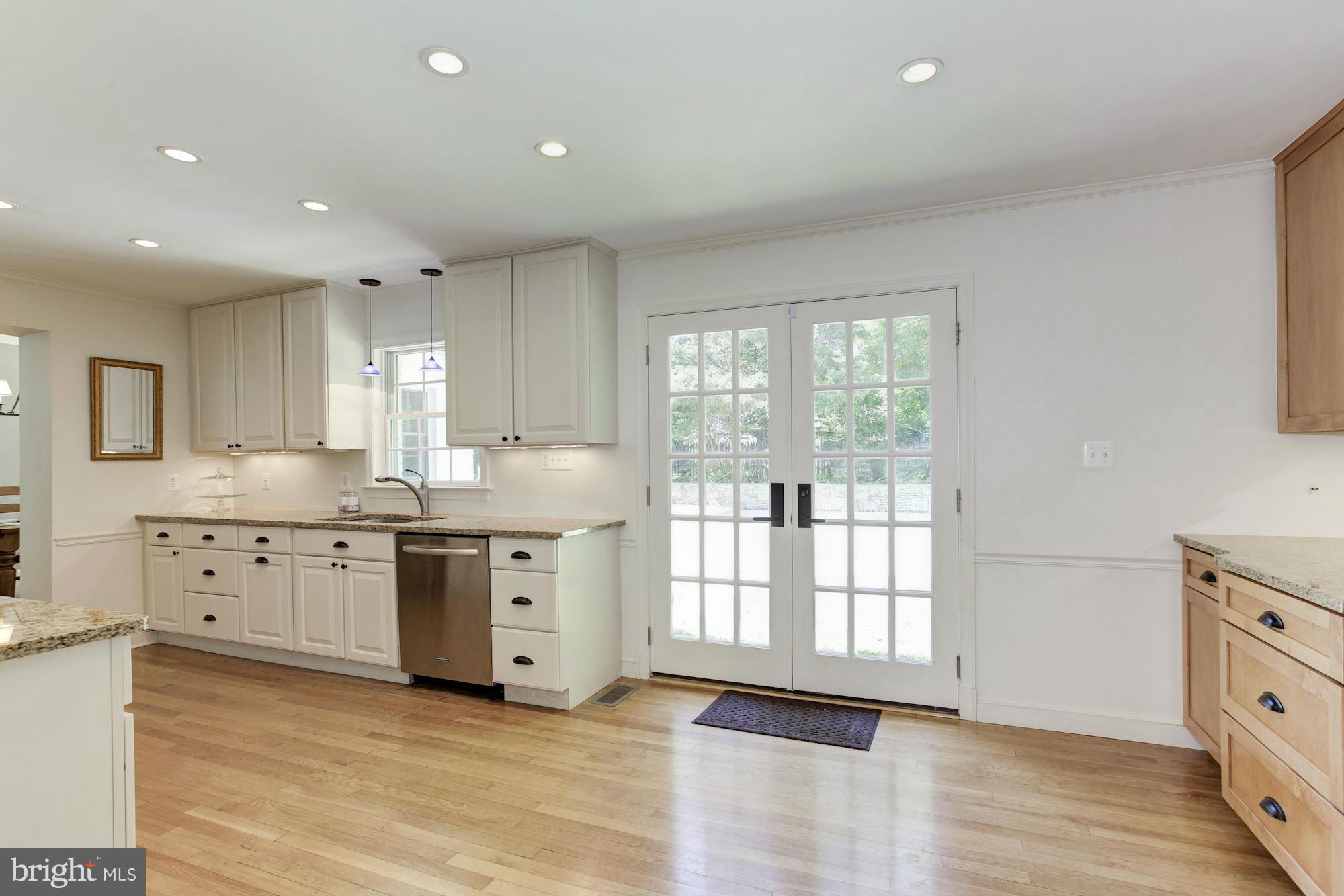 5608 Pollard Road Bethesda, MD 20816 - Photo 7 of 18 a large kitchen with granite countertop a large window and a sink